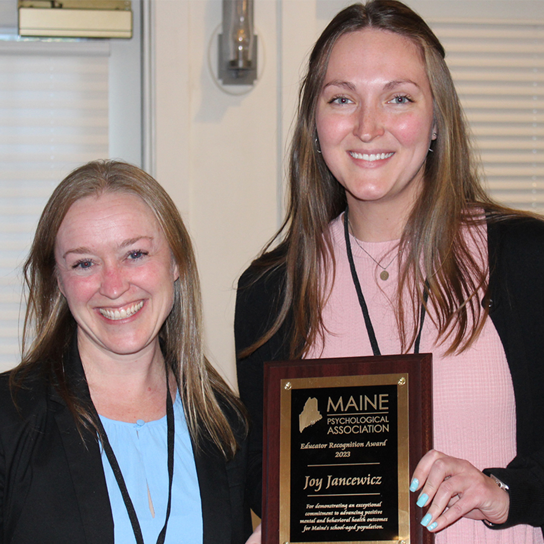 President Jamie Pratt presents the Educator of the Year award to Joy Jancewicz.